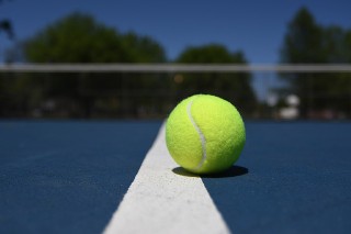 tennis ball on blue court resized
